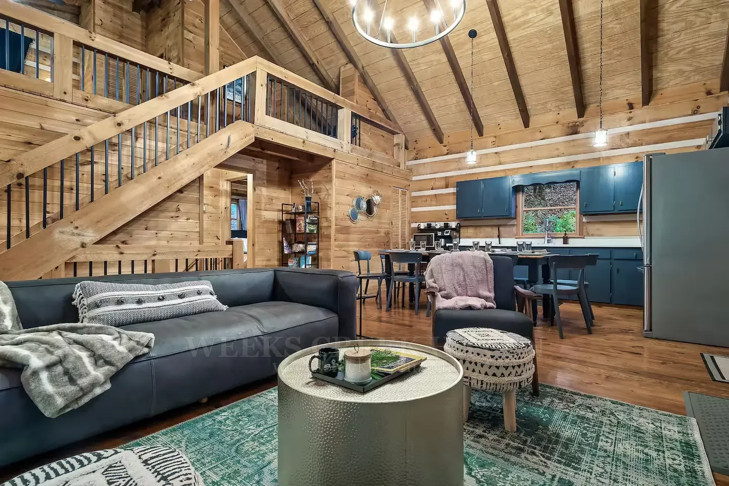 Warm, high-ceiling living room inside Weeks Creek Haven